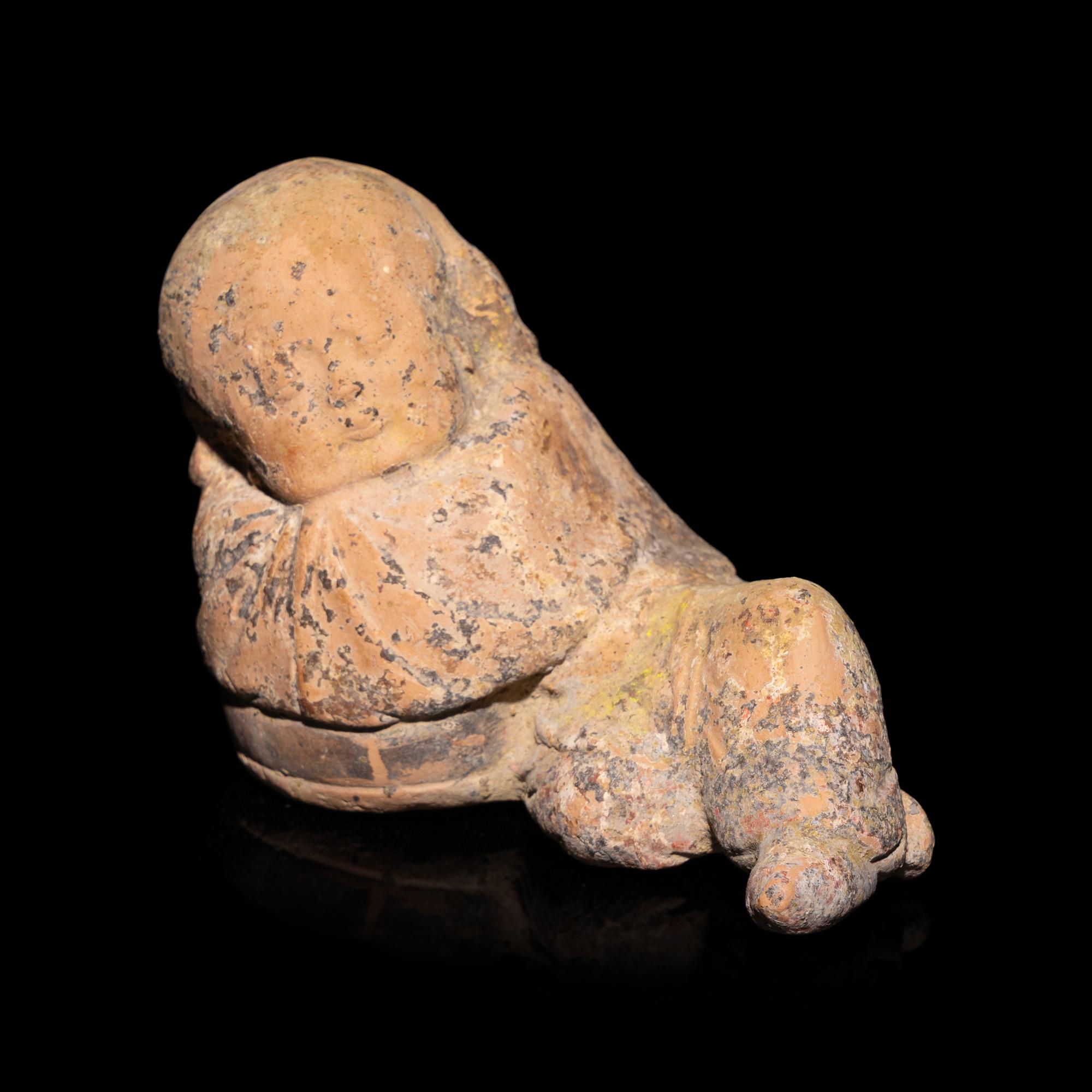 A Chinese Painted Pottery Figure of a Girl, Song Dynasty — 宋 彩繪陶臥女童