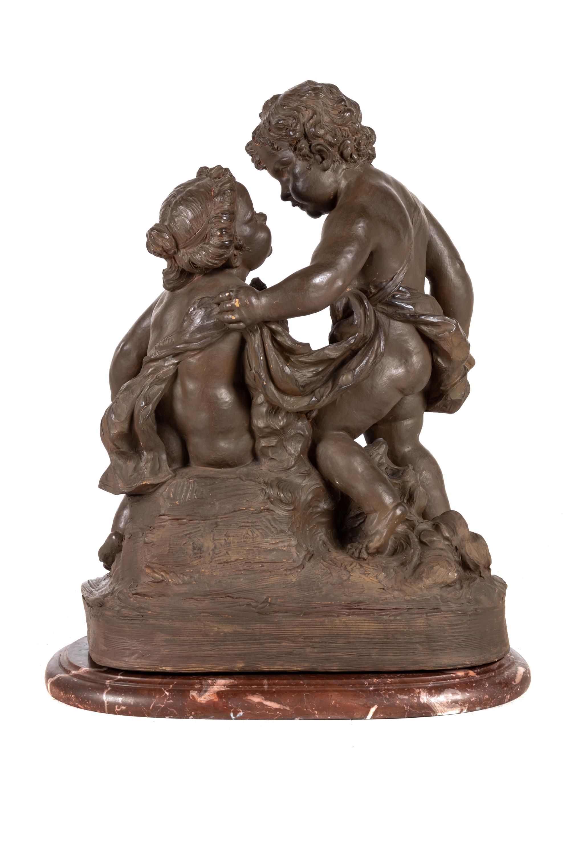 A French Painted Terra Cotta Figural Group of Amorous Putti