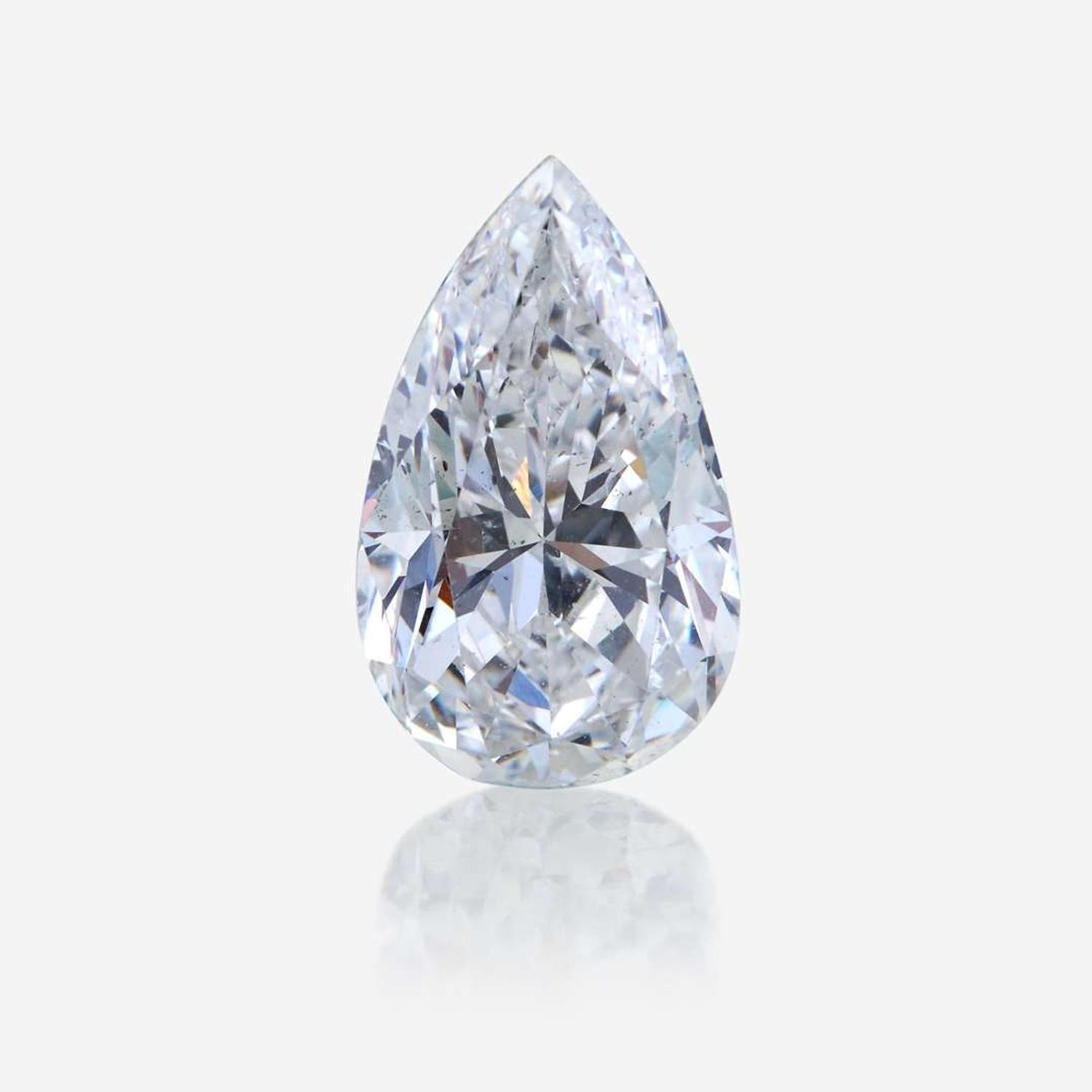 A diamond, colored diamond, and ten karat white gold pendant