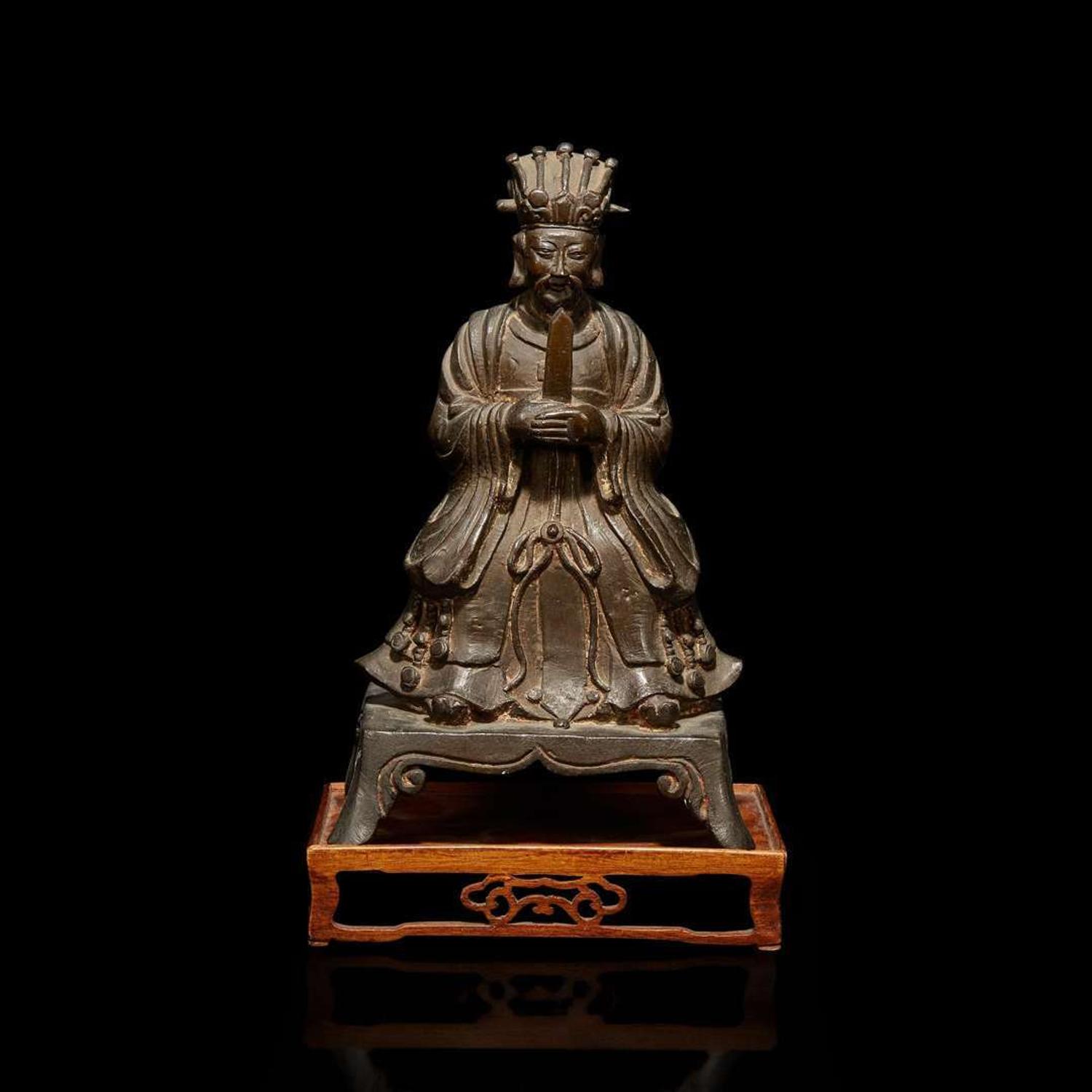 A Chinese bronze figure of a seated Daoist immortal with wood stand 道教仙人銅像與木底座 Ming dynasty ?