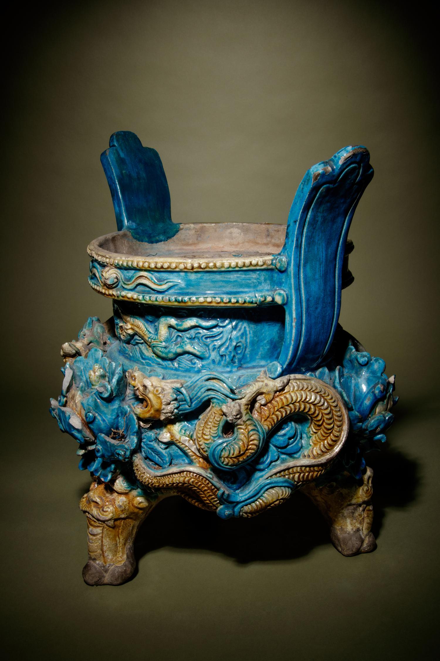 A Turquoise and Ochre Glazed Tileworks Tripod Incense Burner