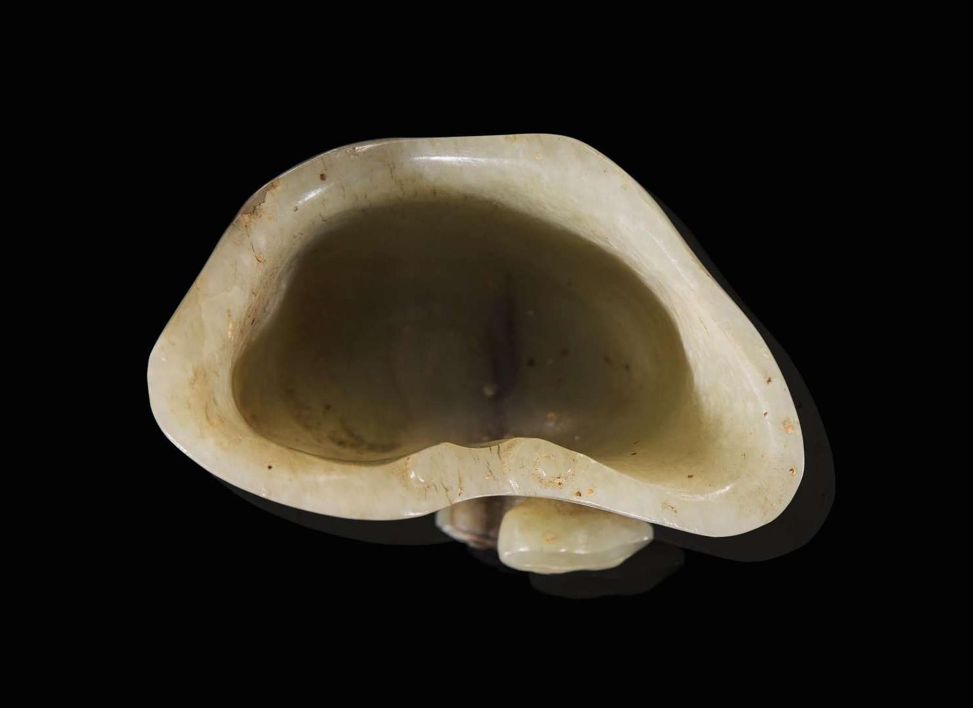 A small Chinese carved greyish-celadon and brown jade coupe, Qing dynasty or earlier 青灰玉小爵杯 清或更早