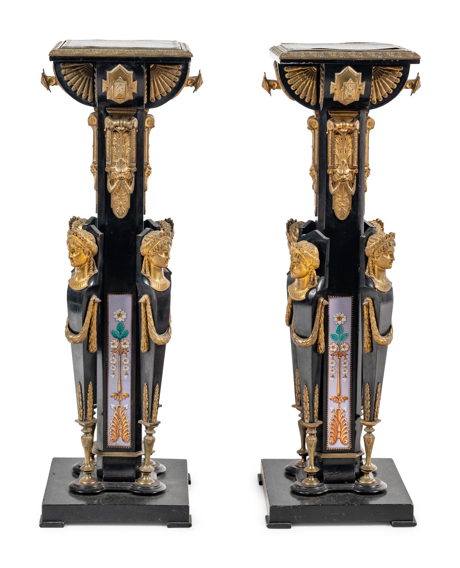 A Pair of Egyptian Revival Gilt Bronze and Porcelain Mounted Ebonized Pedestals