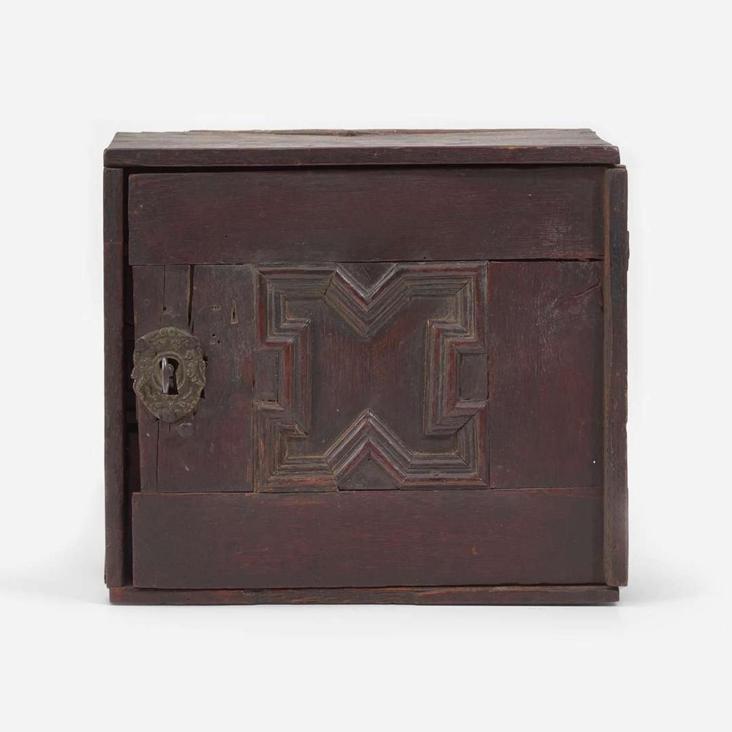 A Charles I carved oak wall-hanging spice cupboard circa 1650