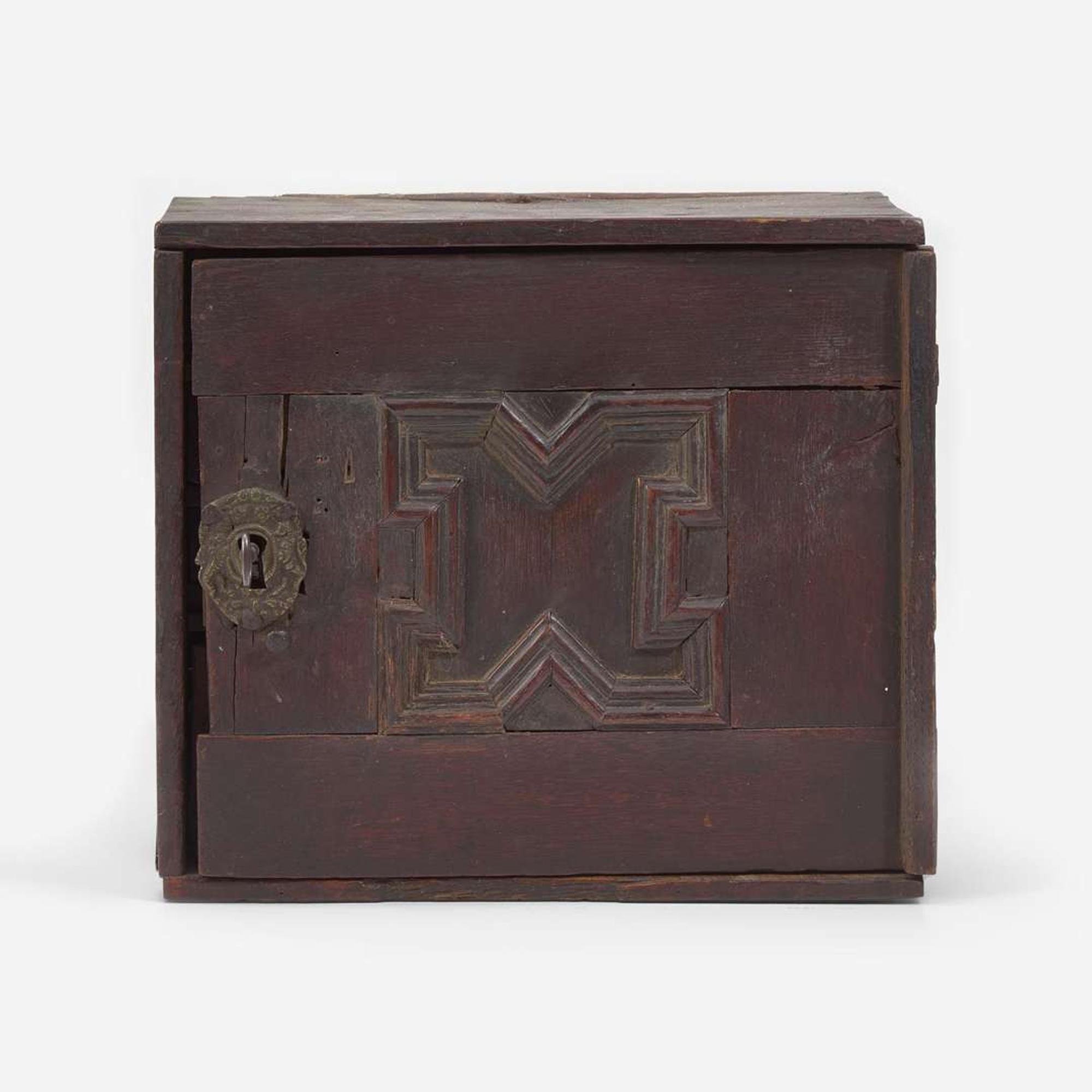 A Charles I carved oak wall-hanging spice cupboard circa 1650