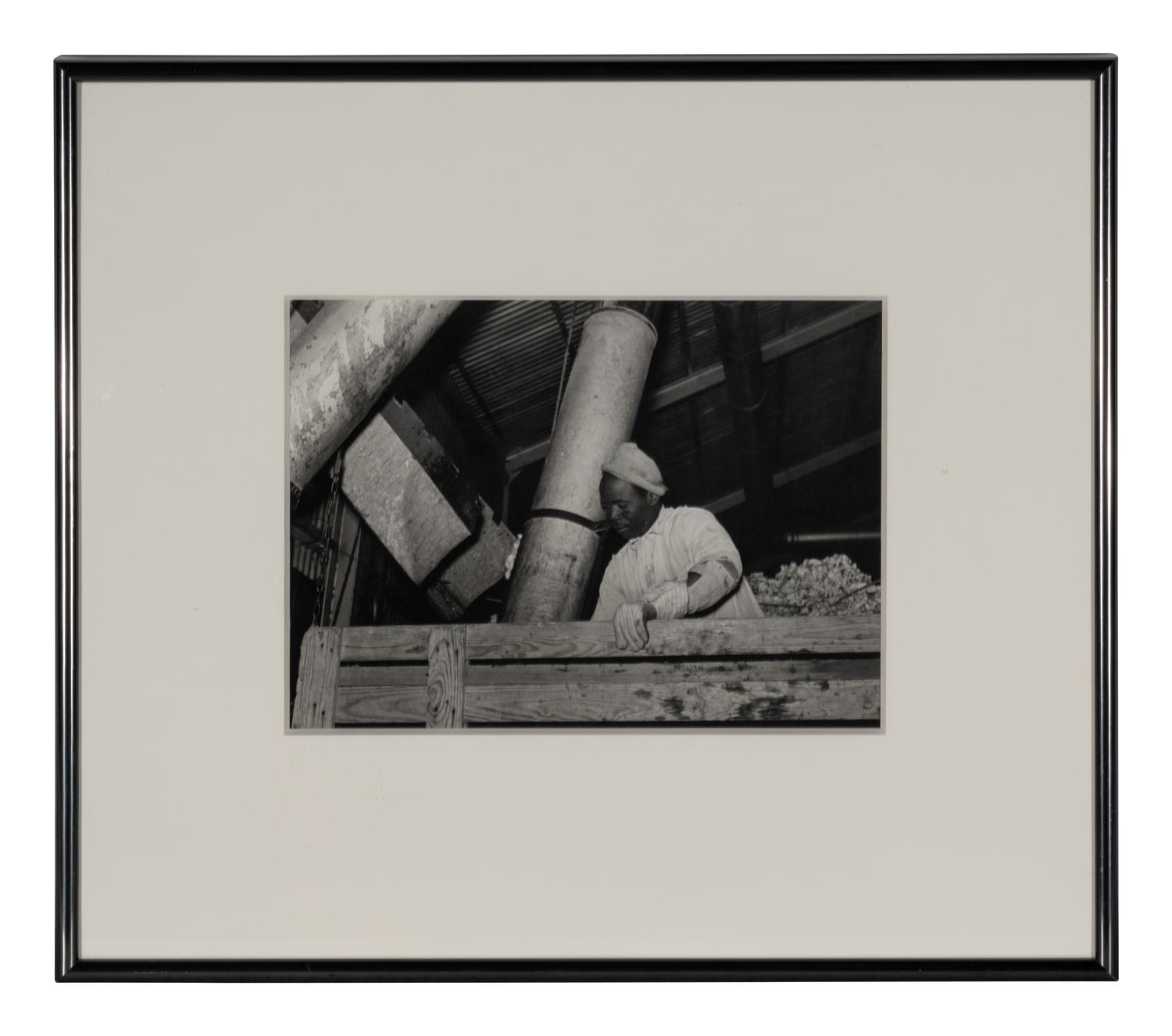 Taking the cotton from the truck into the gin through large metal suction tube. Hopson Plantation. Clarksdale, Miss, 1939