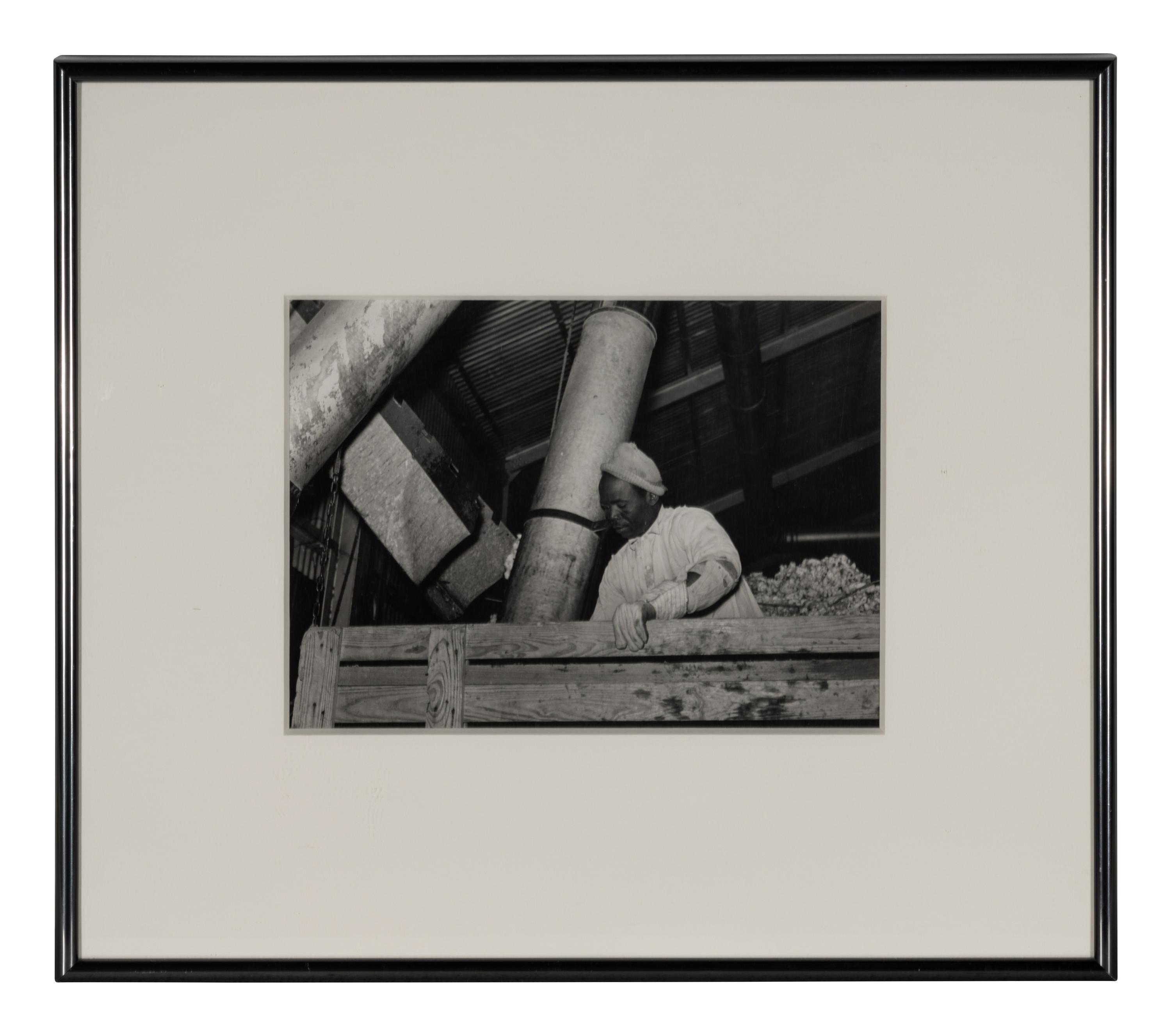 Taking the cotton from the truck into the gin through large metal suction tube. Hopson Plantation. Clarksdale, Miss, 1939