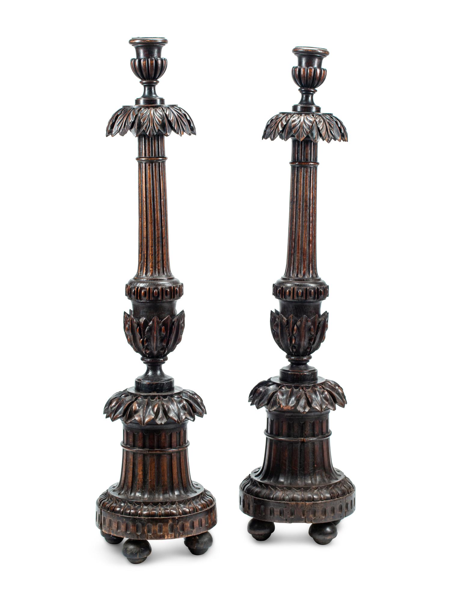 A Pair of Italian Carved Walnut Torchères