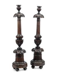 A Pair of Italian Carved Walnut Torchères