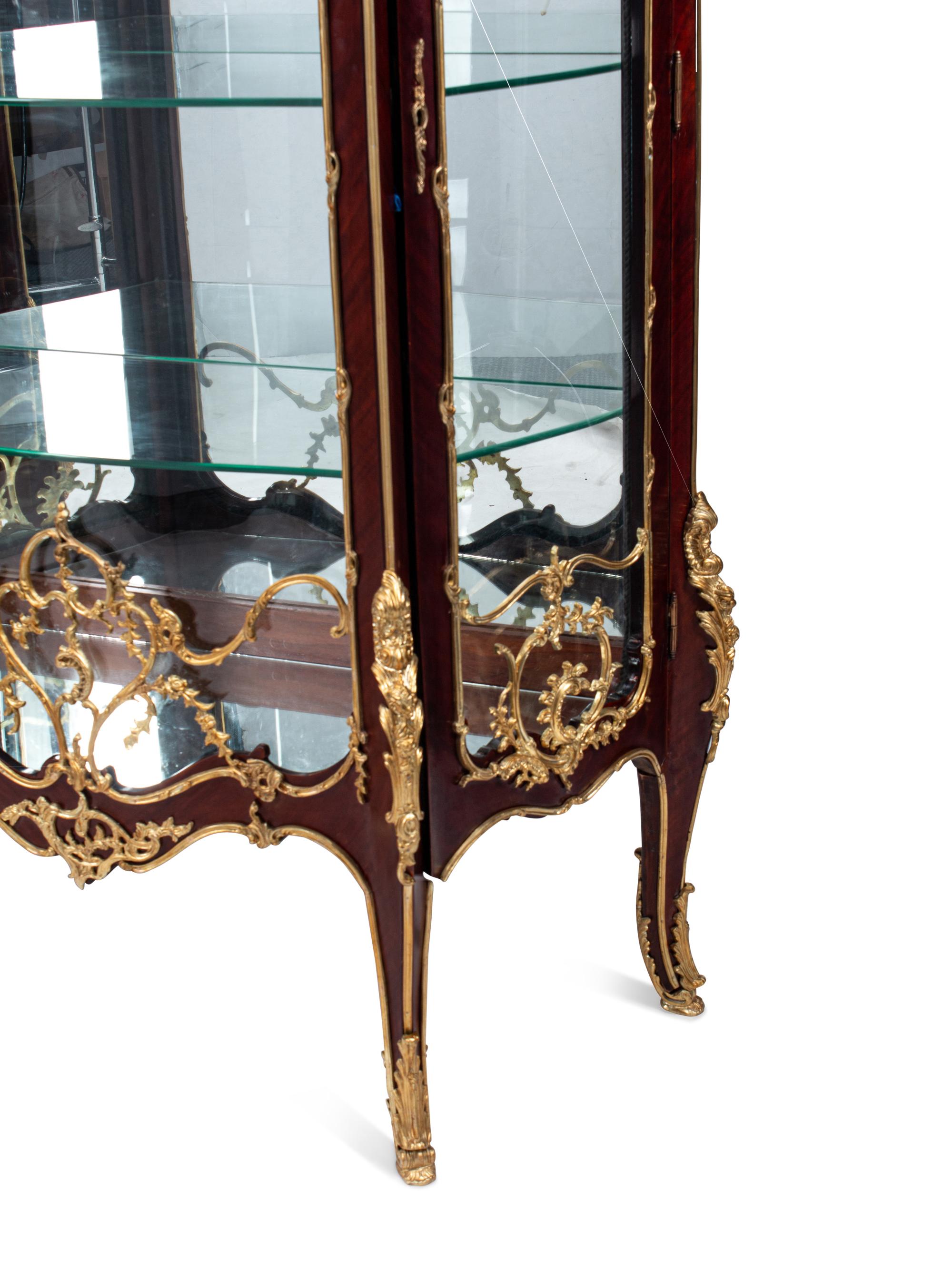 A Pair of Louis XV Style Gilt Bronze Mounted Mahogany Vitrine Cabinets