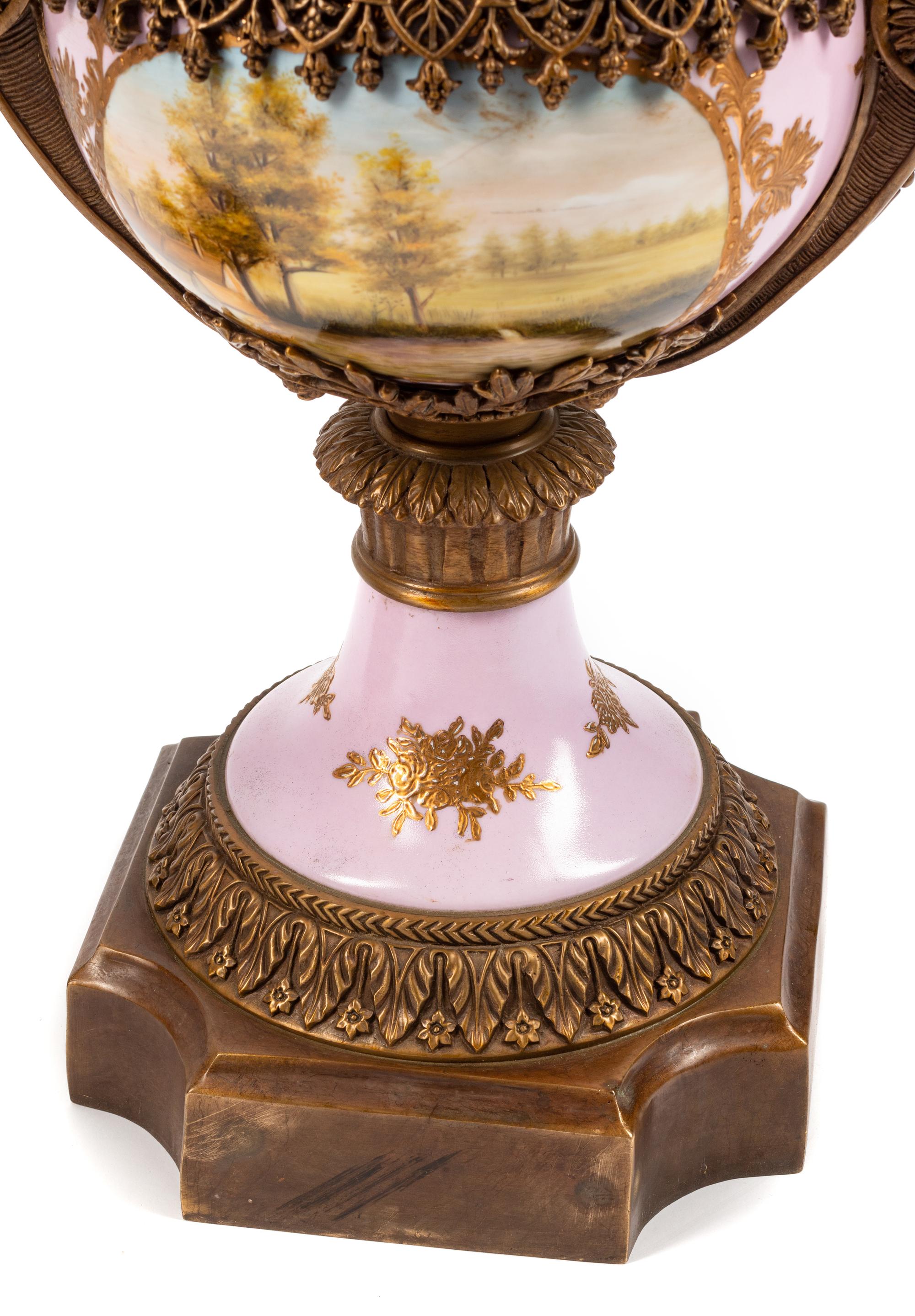 A Pair of Sèvres Style Gilt Bronze Mounted Porcelain Urns