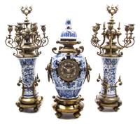 A Gilt Metal and Delft Pottery Clock Garniture Height of tallest 28 1/2 inches. — MOVEMENT BY H.L. LUPPENS