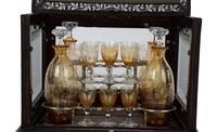 A French Ebonized and Inlaid Cave à Liqueur with Amber Glass Decanters — LATE 19TH CENTURY