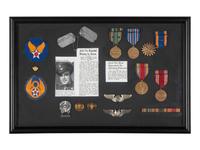 [WORLD WAR II]. Two framed displays featuring medals and patches of identified soldiers.