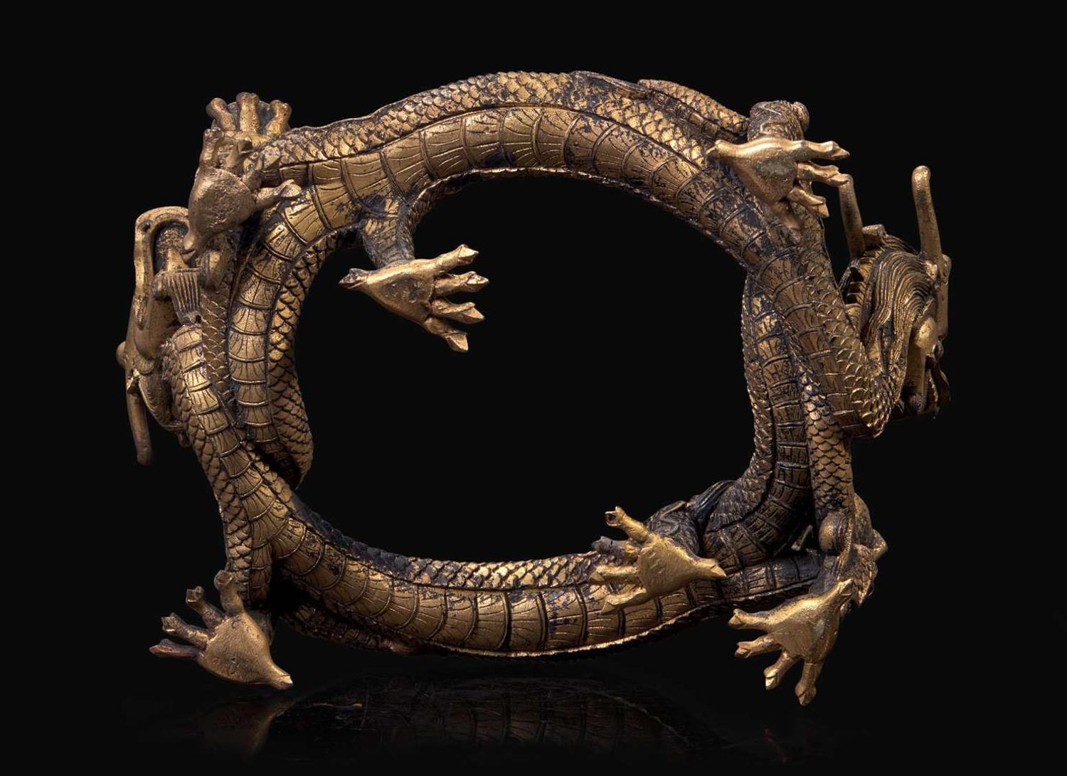 A Chinese gilt bronze “Dragons” stand, Qing dynasty, 18th/19th century 銅鎏金龍形底座 清 十八或十九世紀