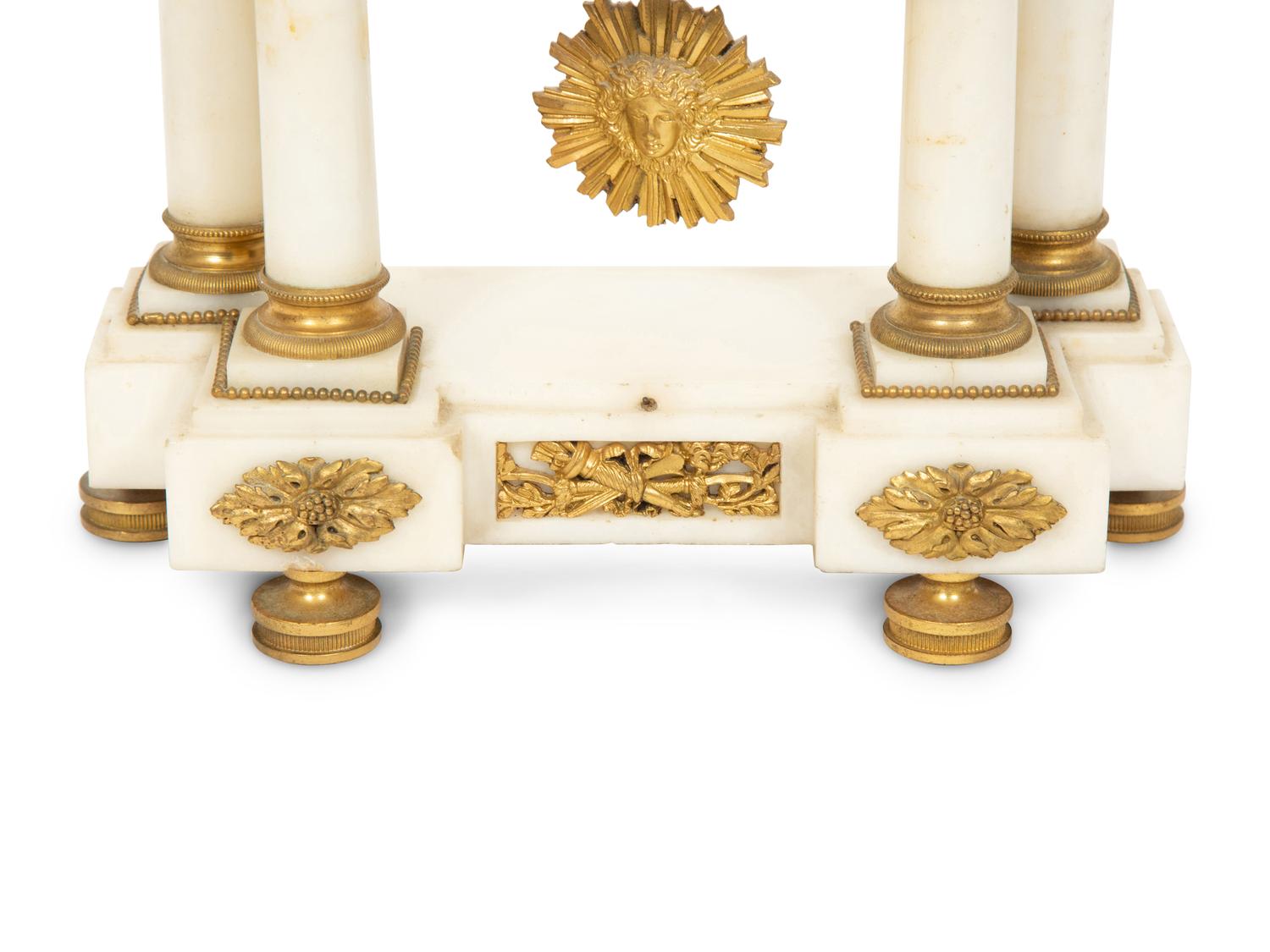 An Empire Style Gilt Bronze Mounted Marble Portico Clock