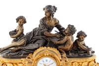 A French Gilt and Patinated Bronze Clock Garniture