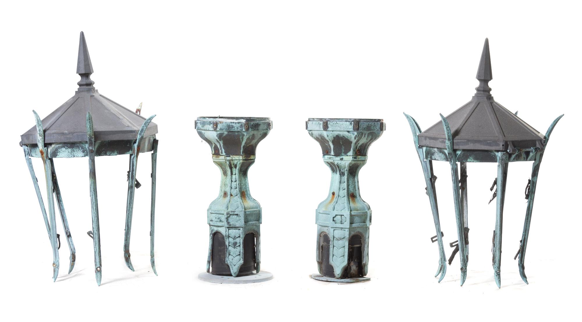 A Pair of Patinated Cast Metal Lanterns Height 53 inches.