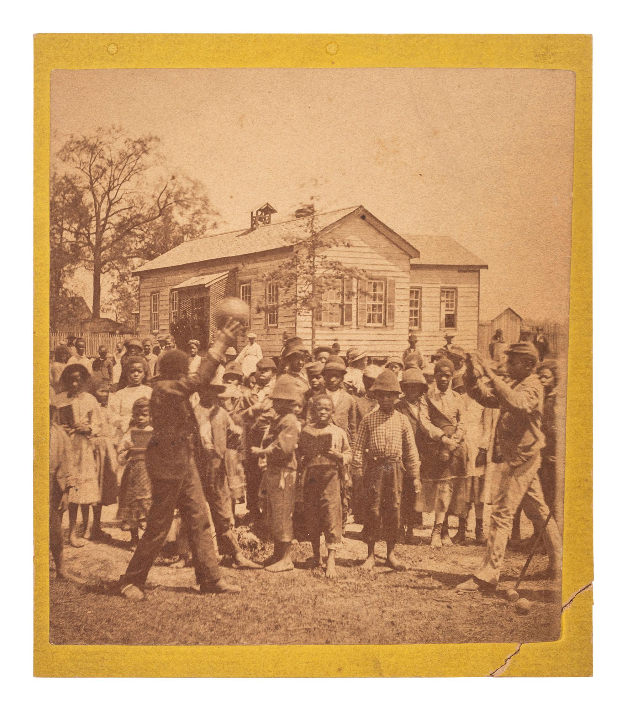 [EARLY PHOTOGRAPHY]. Mounted albumen photograph of African American children playing a game. Ca 1860s.