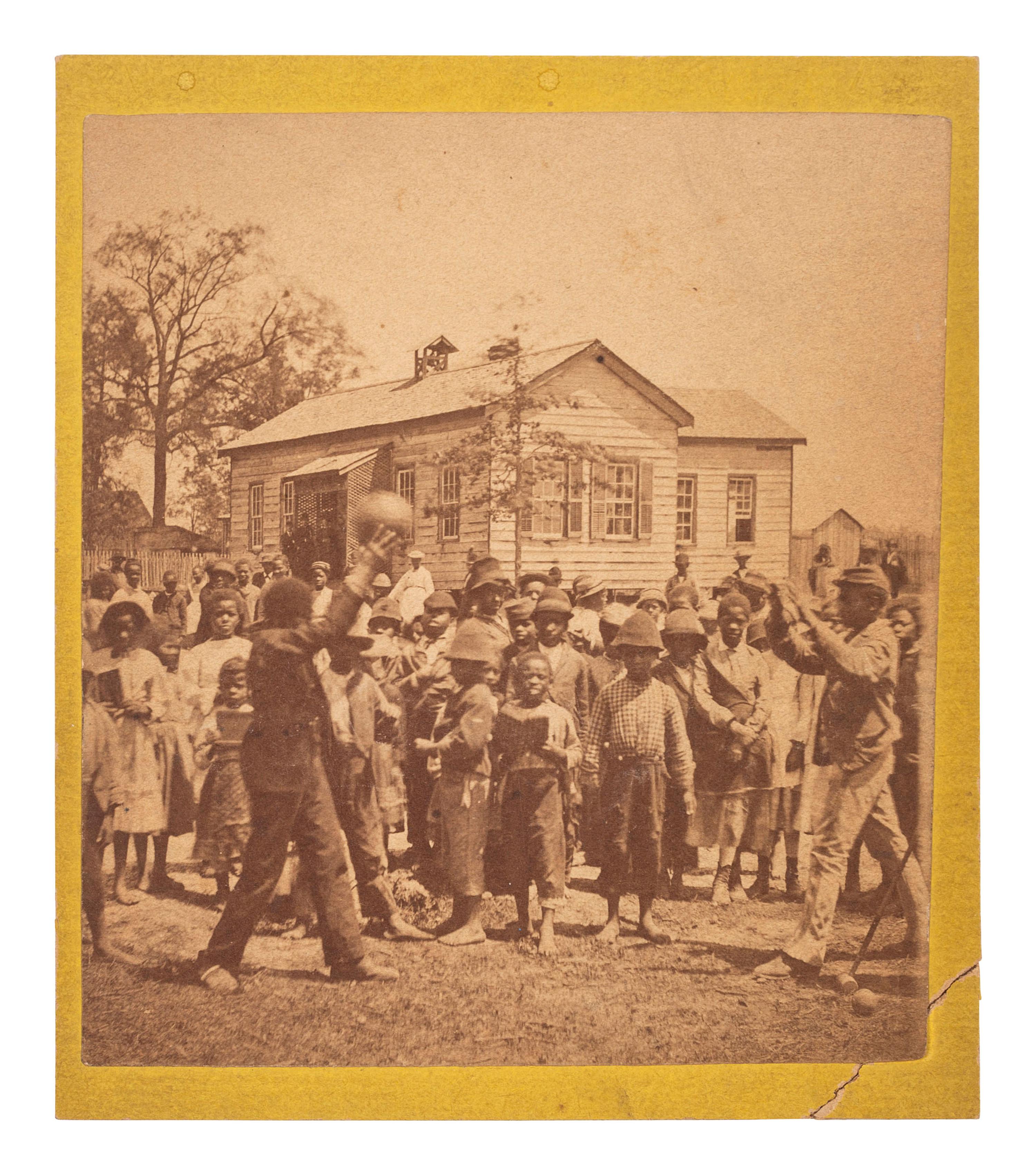 [EARLY PHOTOGRAPHY]. Mounted albumen photograph of African American children playing a game. Ca 1860s.