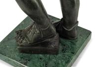 A Continental Patinated Bronze Figure with a Rock Crystal Ornament