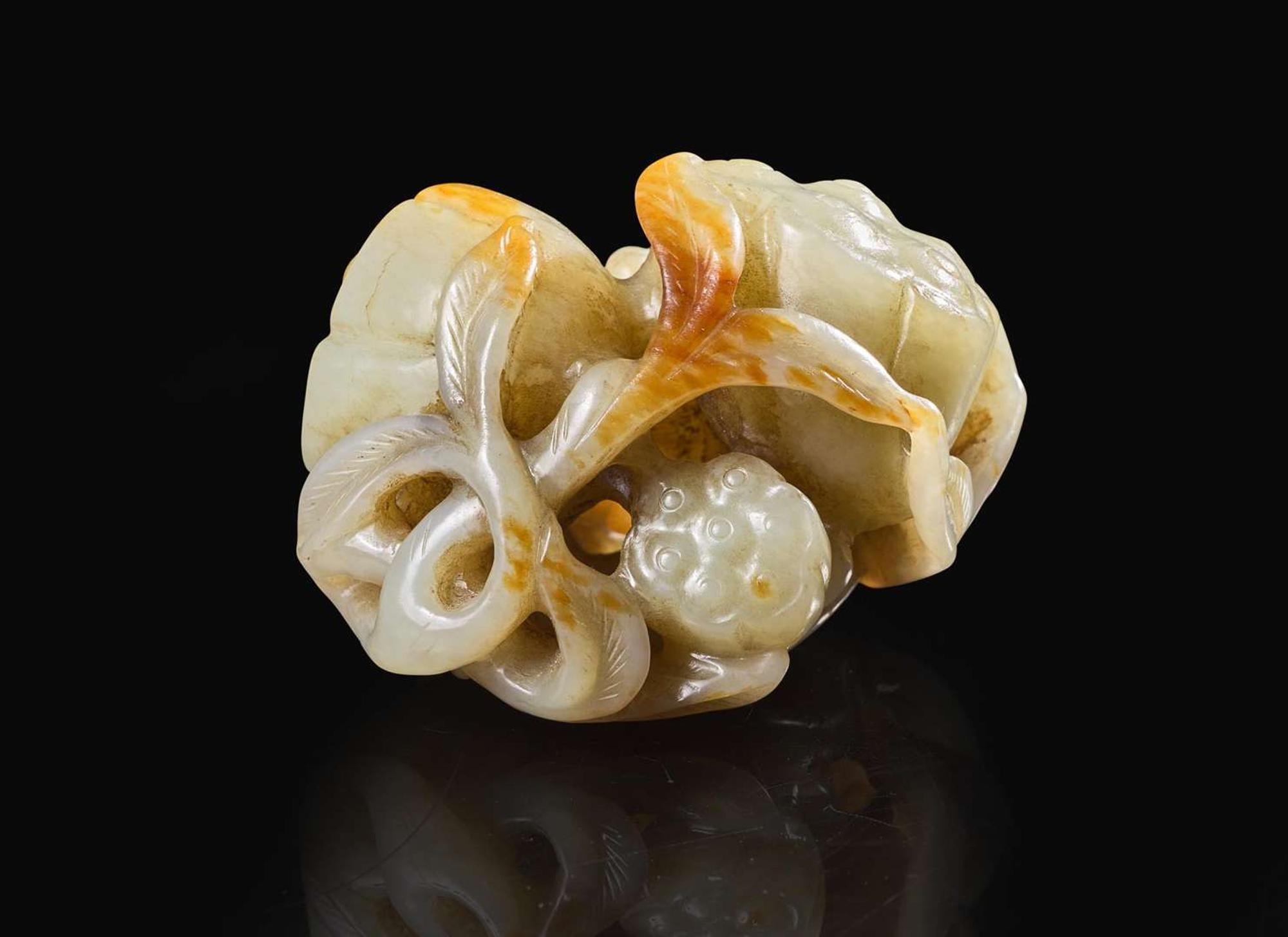 A Chinese carved pale celadon and russet jade "Lotus" group, Qing dynasty 青白玉荷蓮玉雕 清