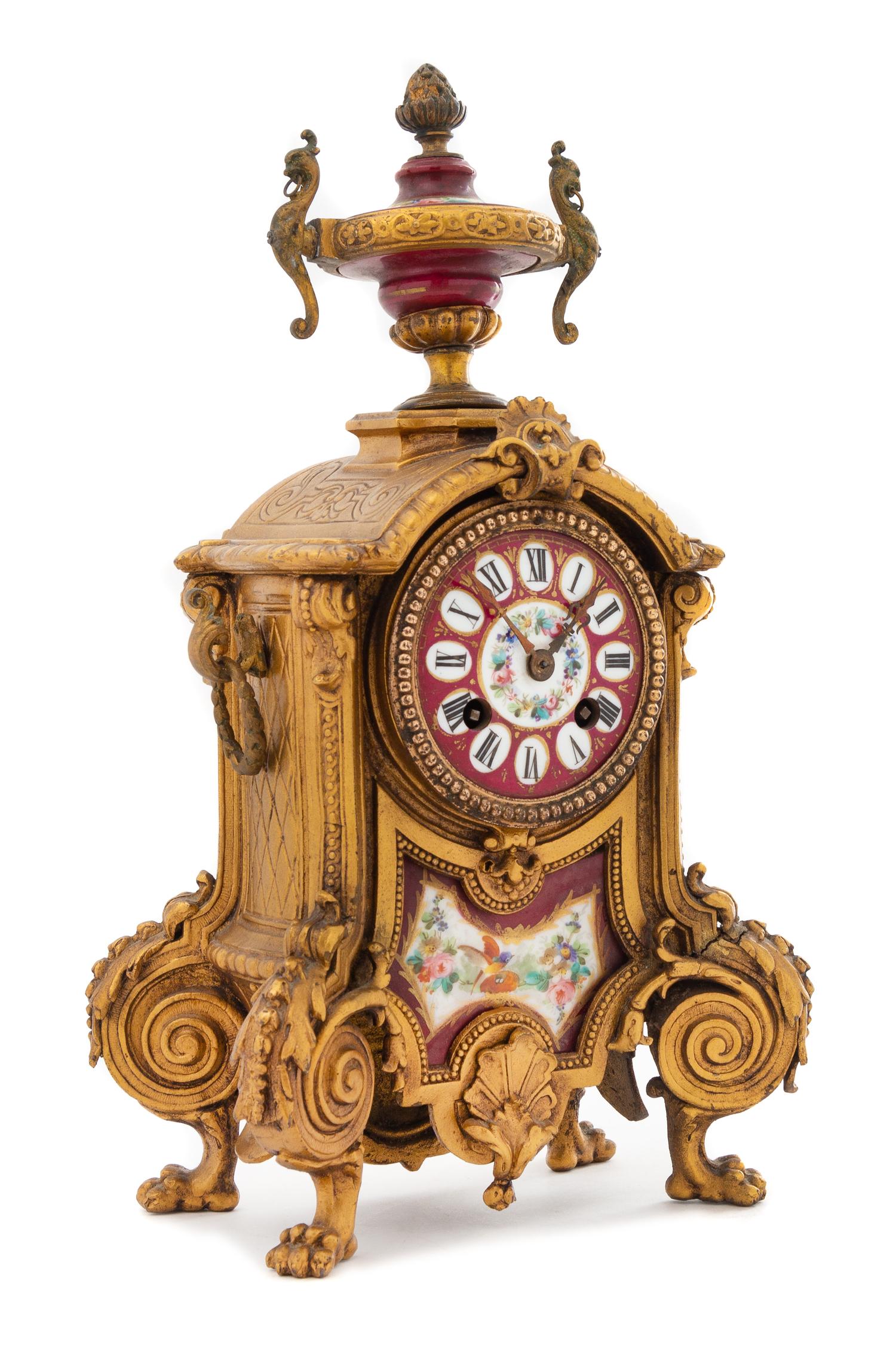 A French Porcelain Inset Gilt Metal Mantel Clock