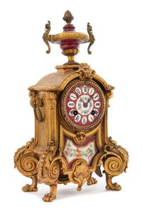 A French Porcelain Inset Gilt Metal Mantel Clock