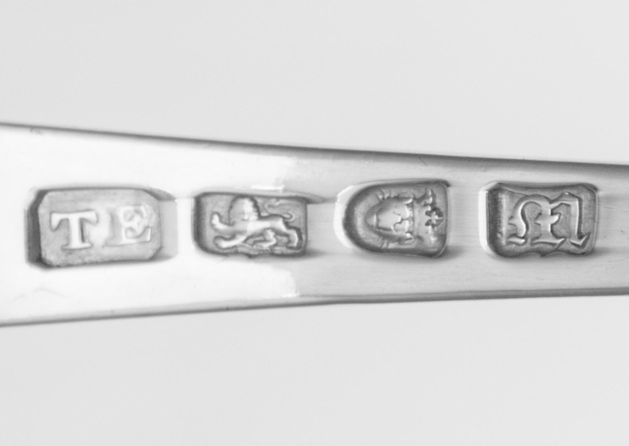 A George III Silver Ladle, Mark of Thomas Ellis, London, 1767, having a rocaille decorated bowl, the handle with a downturned end with