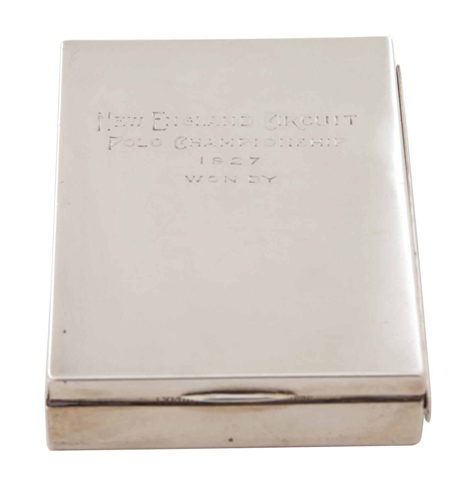 An American Silver Cigarette Case, Cartier, New York, NY, inscribed New England Circuit/Polo Championship/1927/Won by; having a gilt wa