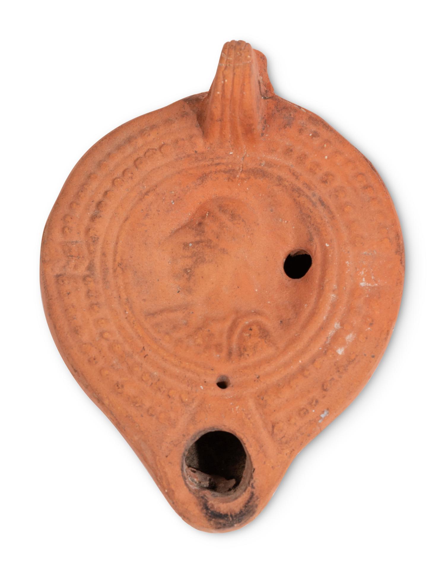 Ten Roman Terracotta Oil Lamps and a Holy Land Pottery Jug