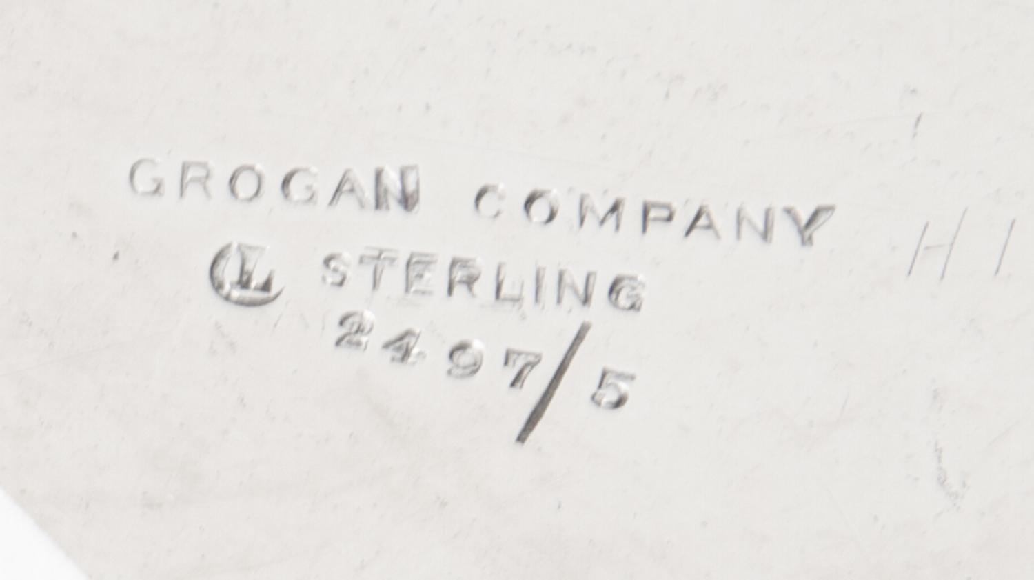 An American Silver Fruit Basket, Grogan Company, Pittsburgh, PA, with a swing handle, pierced sides and engraved foliate scrolls.