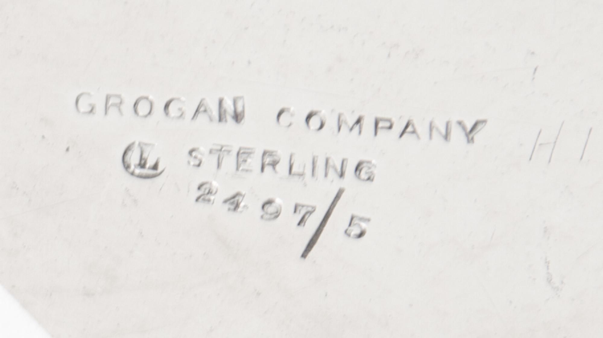 An American Silver Fruit Basket, Grogan Company, Pittsburgh, PA, with a swing handle, pierced sides and engraved foliate scrolls.