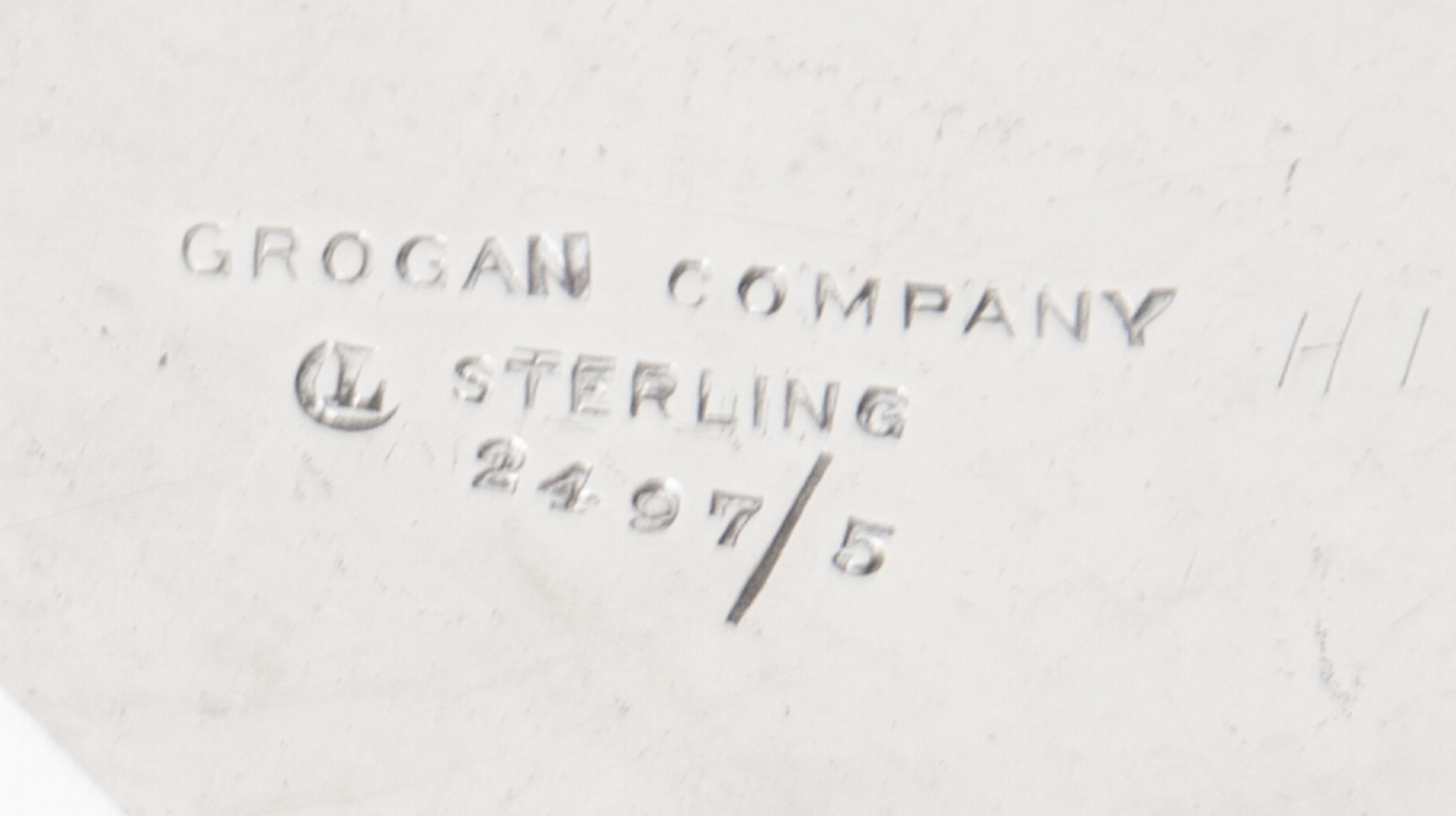 An American Silver Fruit Basket, Grogan Company, Pittsburgh, PA, with a swing handle, pierced sides and engraved foliate scrolls.