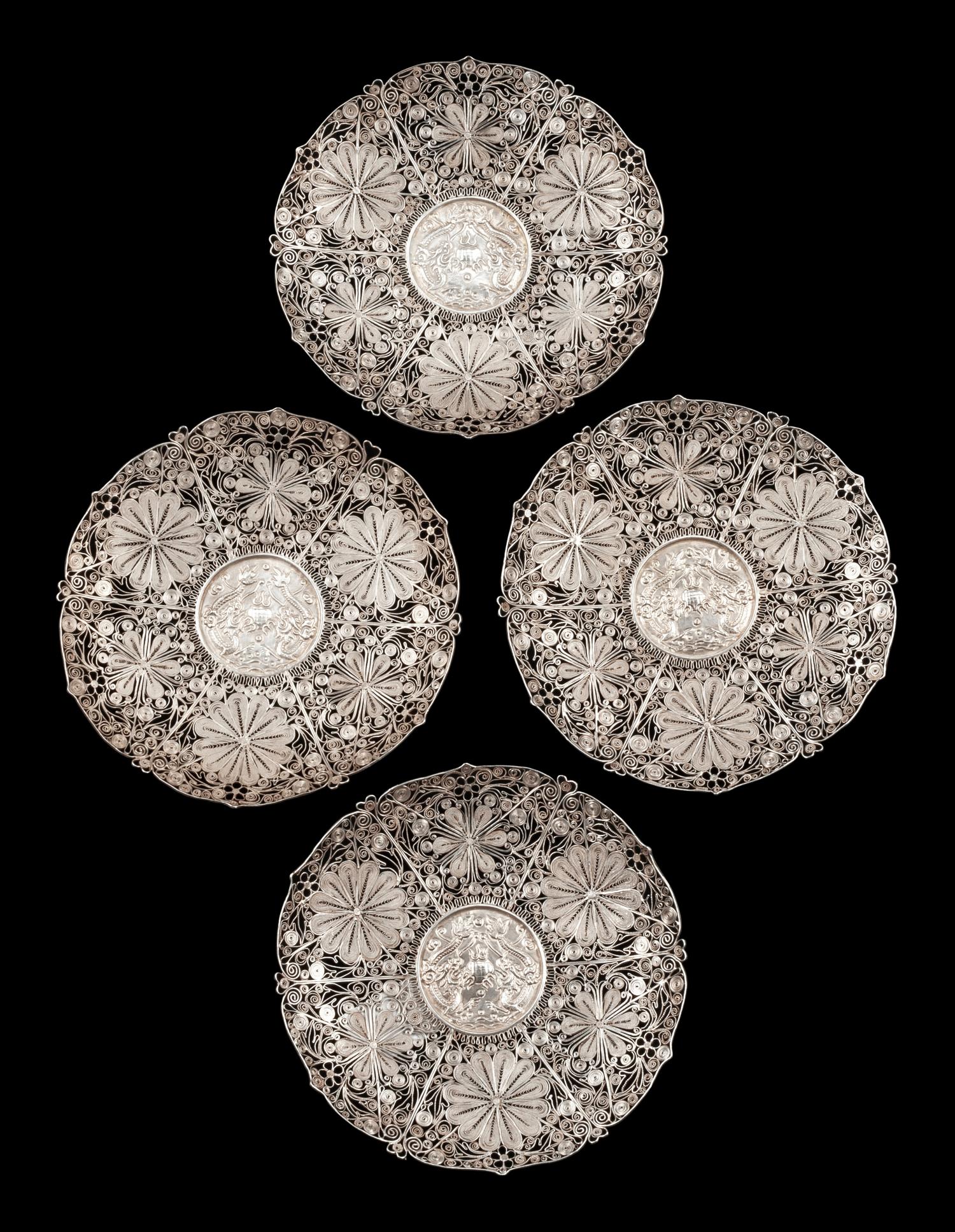 A Set of Four Silver Filigree Plates