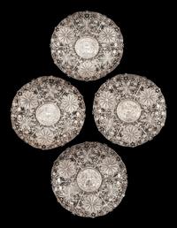 A Set of Four Silver Filigree Plates