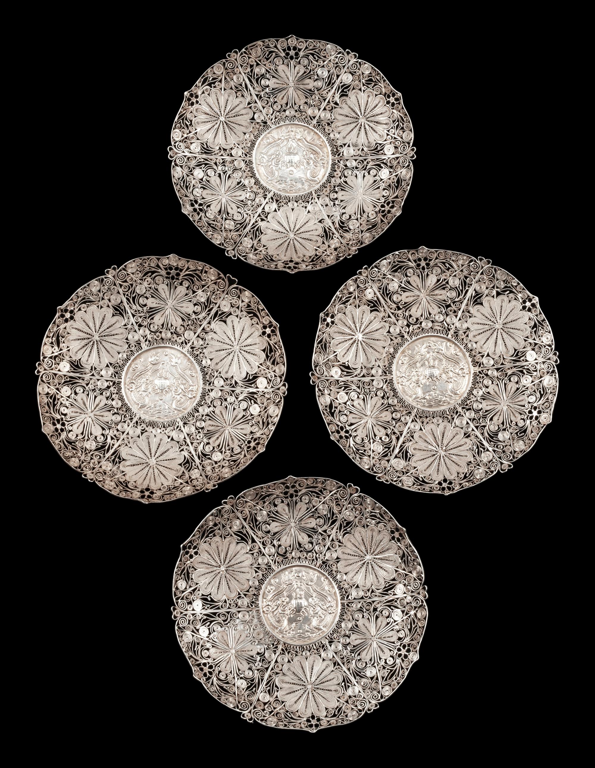 A Set of Four Silver Filigree Plates