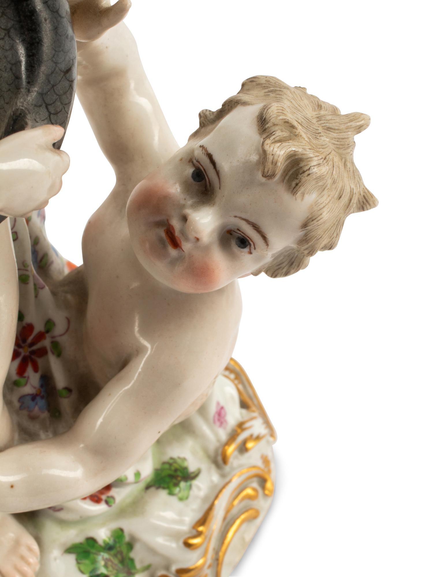 A Pair of Meissen Porcelain Figural Candlesticks