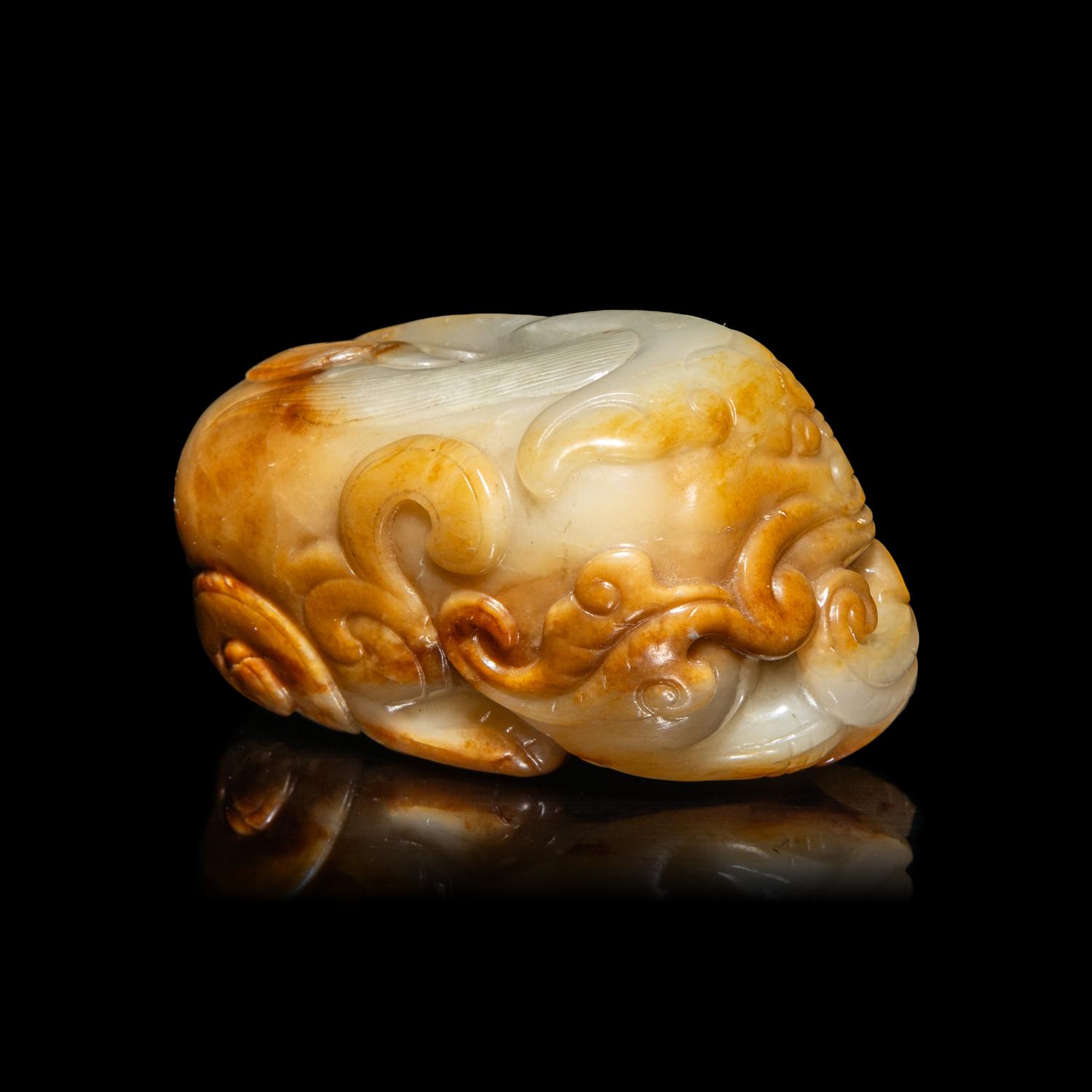 A Chinese White and Russet Jade Mythical Beast, Bixie, Ming Dynasty (1368-1644) 明 白玉辟邪