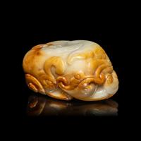 A Chinese White and Russet Jade Mythical Beast, Bixie, Ming Dynasty (1368-1644) 明 白玉辟邪