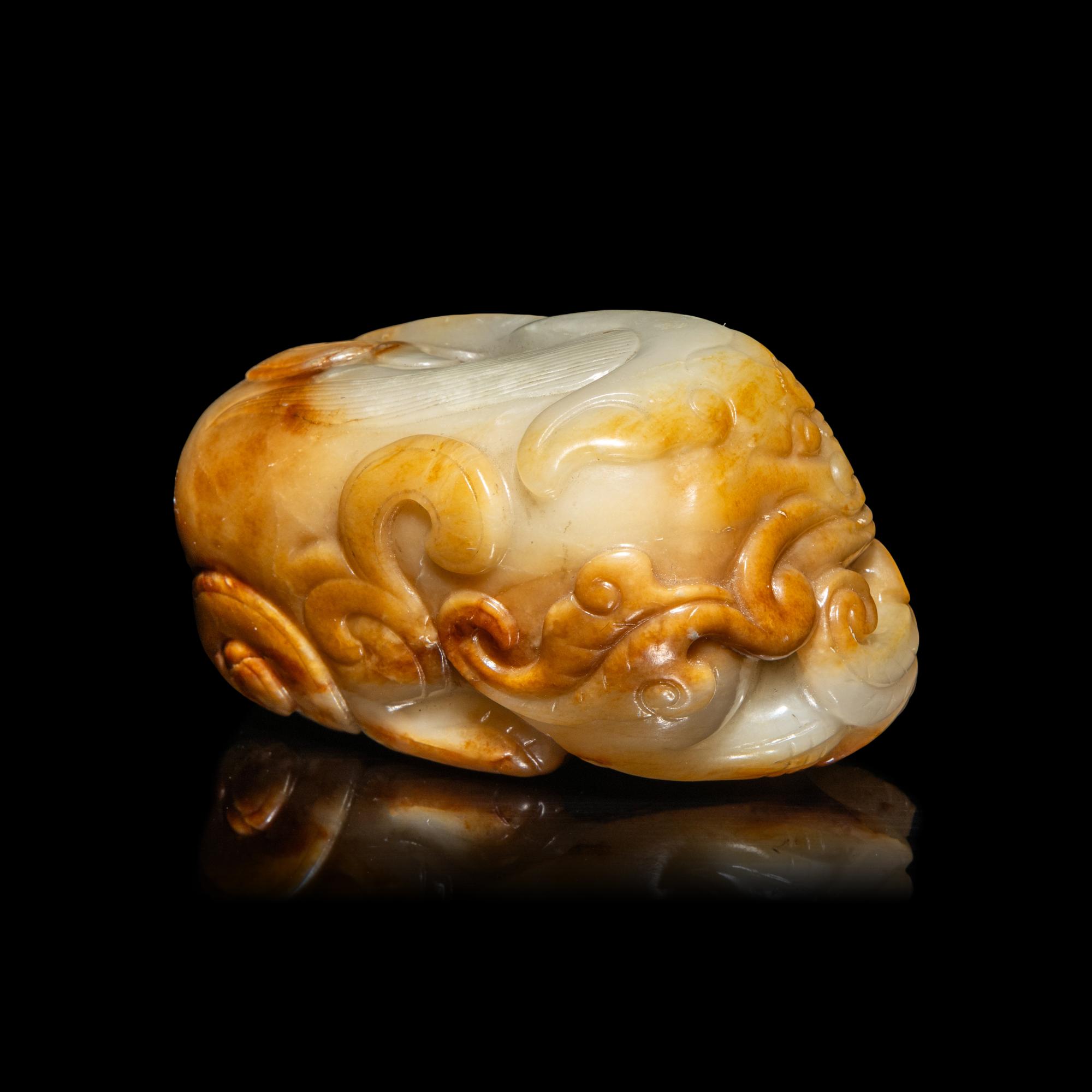 A Chinese White and Russet Jade Mythical Beast, Bixie, Ming Dynasty (1368-1644) 明 白玉辟邪
