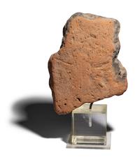 An Egyptian Terracotta Head of Bes