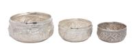 Three Persian Silver Bowls, , having allover chased designs, graduated in size.
