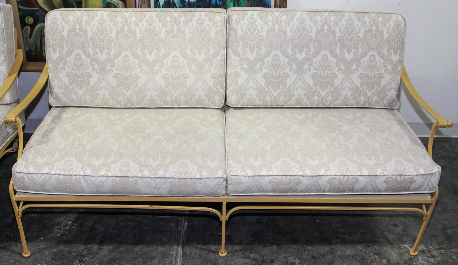 A Pair of Vintage Painted Iron Settees. Height 31 x width 69 x depth 31 1/2 inches.