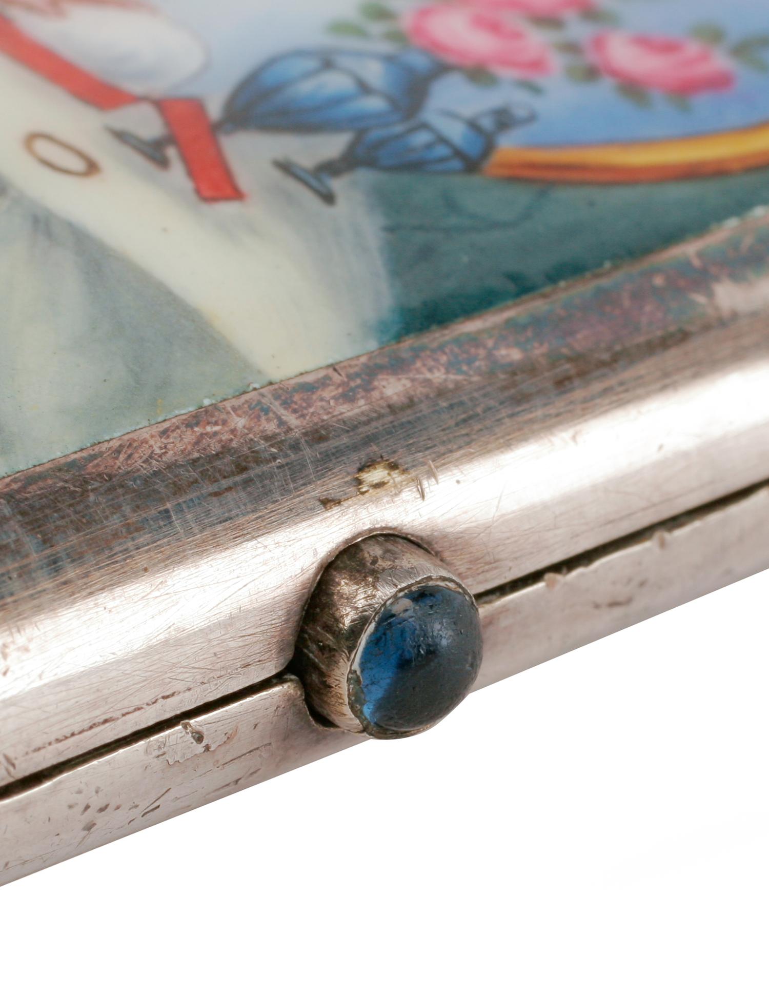 An Enameled Silver Cigarette Case, Late 19th/Early 20th Century, the lid enameled to show a seated nude before a dressing table.