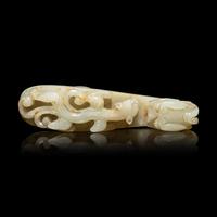 A Chinese Pale Celadon and Russet Jade 'Dragon' Belt Hook, Qing Dynasty 清 青白玉灑金皮蒼龍教子帶鉤
