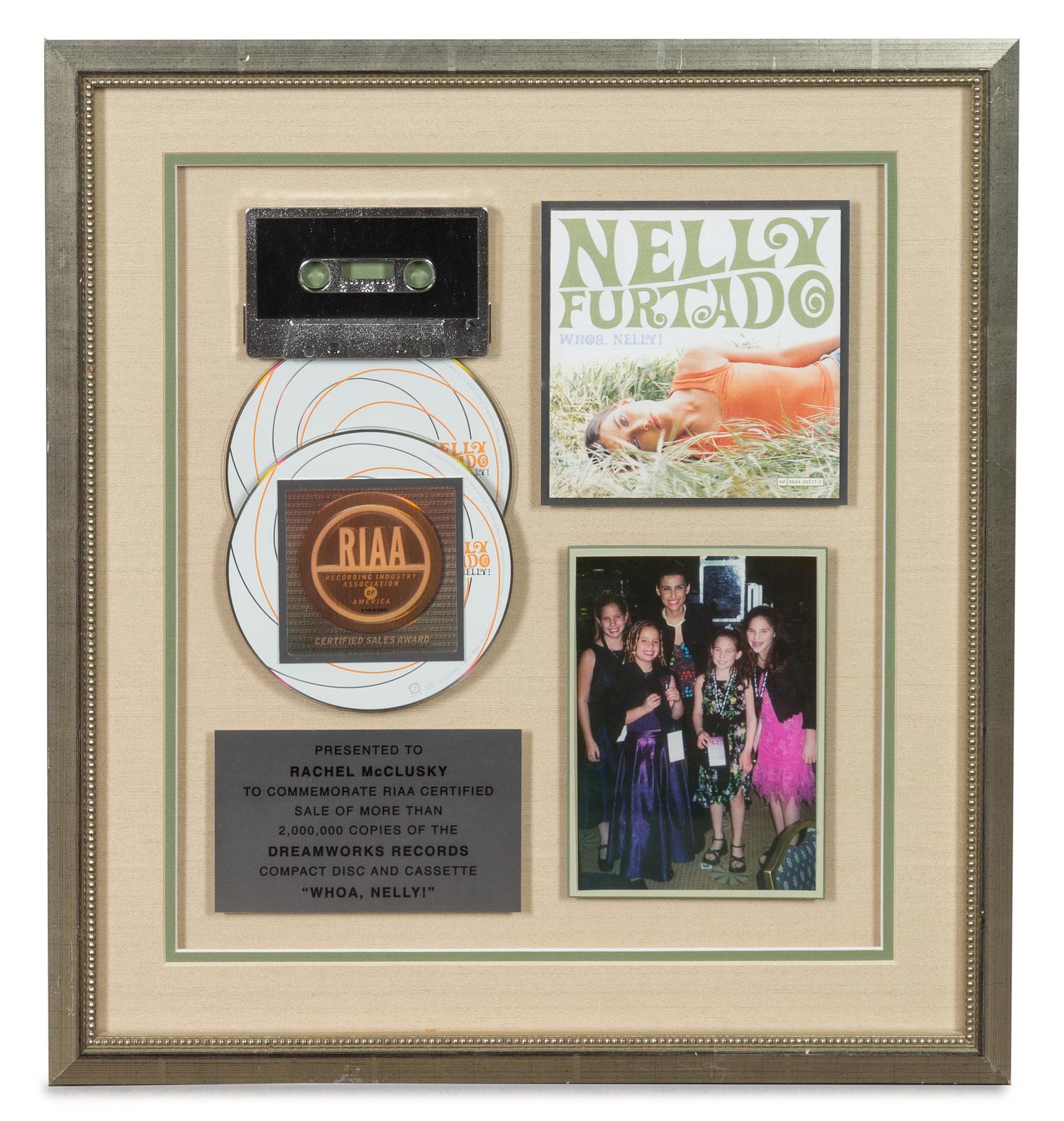 A Nelly Furtado: Woah Nelly RIAA Certified 2x Platinum Presentation Album 17 1/4 x 15 3/4 inches.