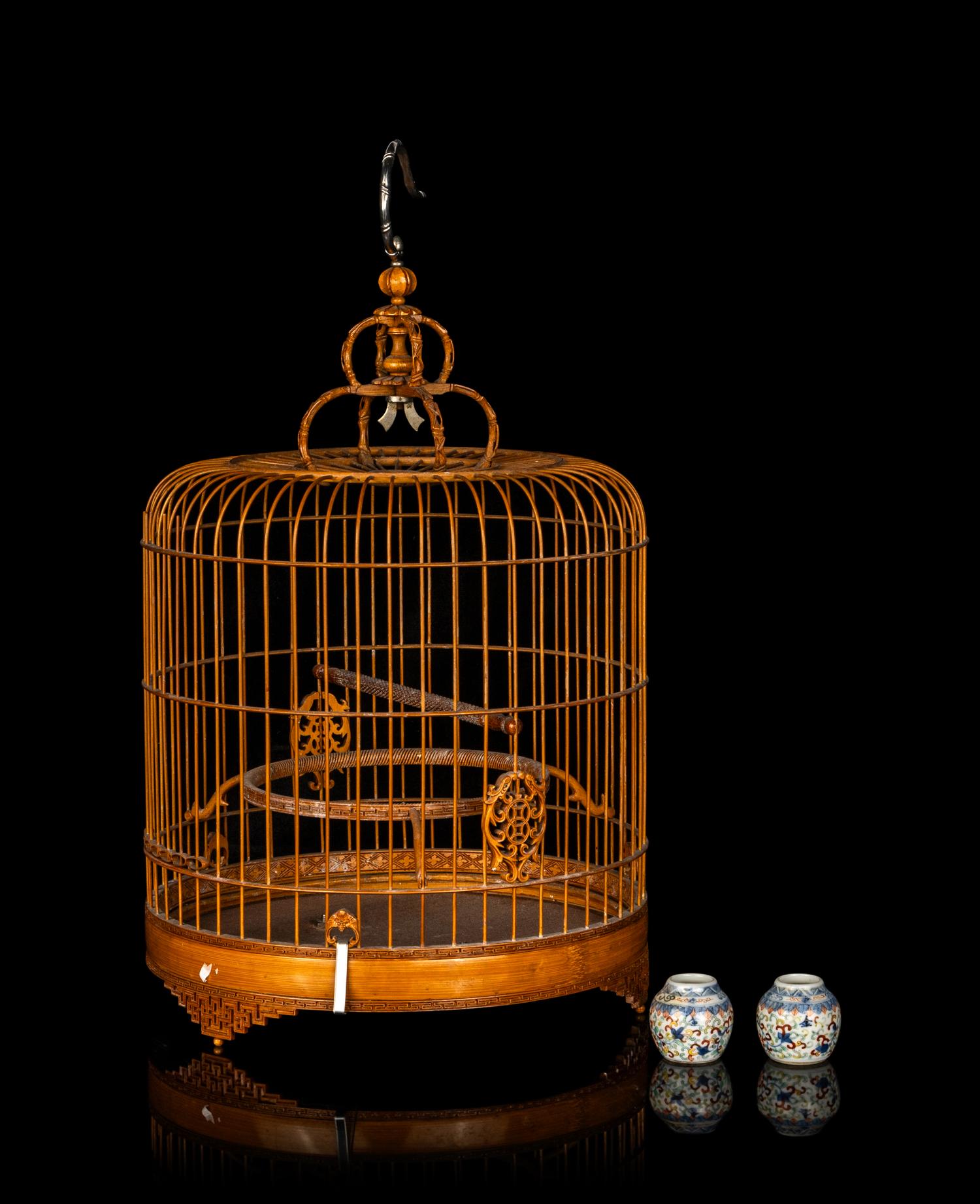 A Chinese Bamboo Bird Cage with A Pair of Wucai Porcelain Bird Feeders