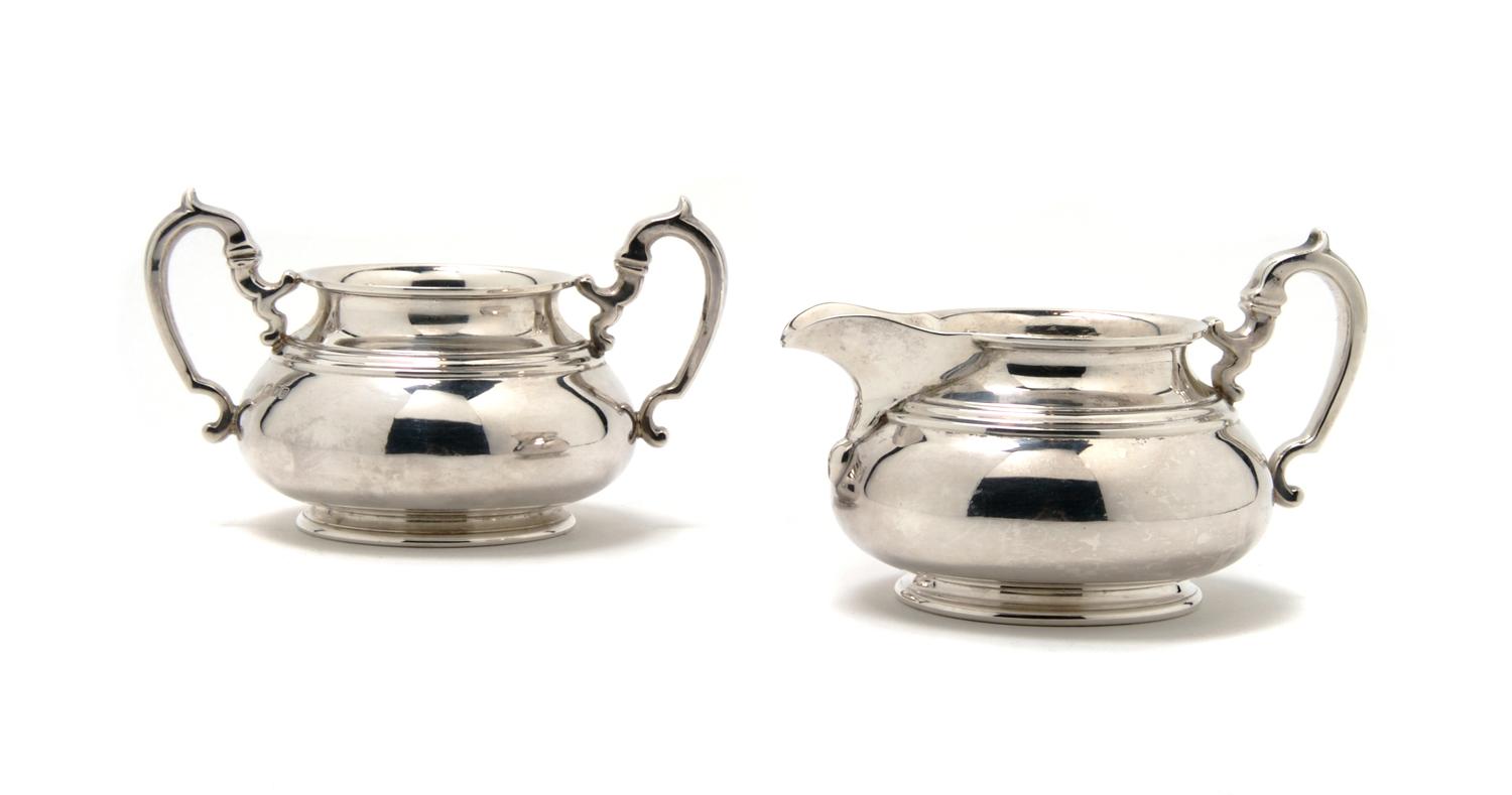 An English Silver Creamer and Sugar, The Goldsmiths & Silversmiths, Height 3 1/2 inches.