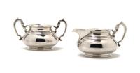 An English Silver Creamer and Sugar, The Goldsmiths & Silversmiths, Height 3 1/2 inches.